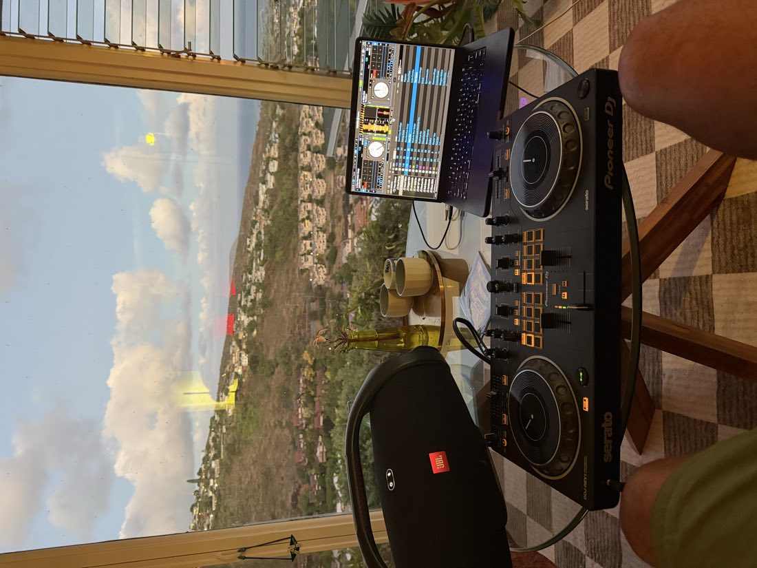 DJ Leanskee Pioneer DDJ-REV7 setup with a Honolulu hillside sunset view