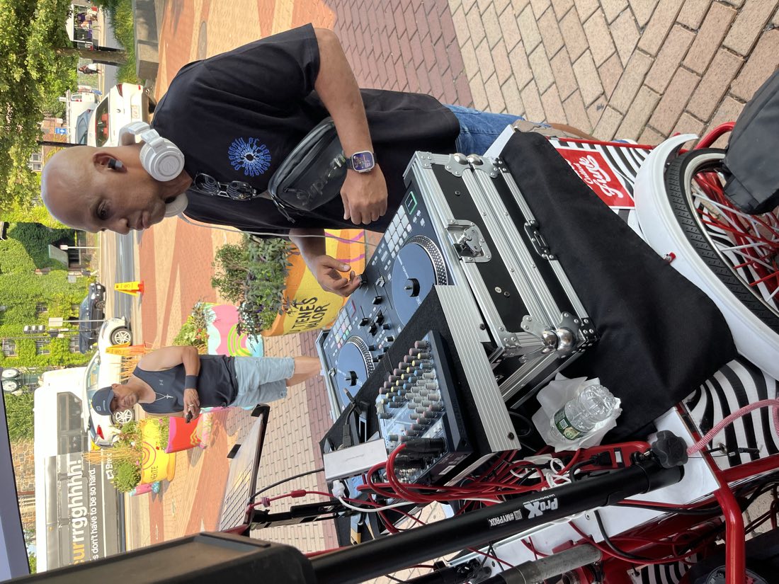DJ Leanskee mixing at an outdoor plaza event